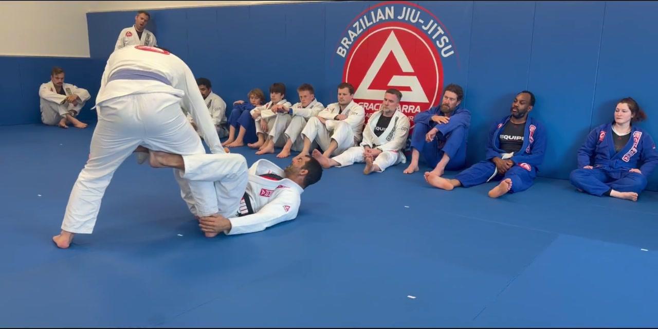 A professor teaching an adult Jiu-Jitsu class at Gracie Barra West Ashley