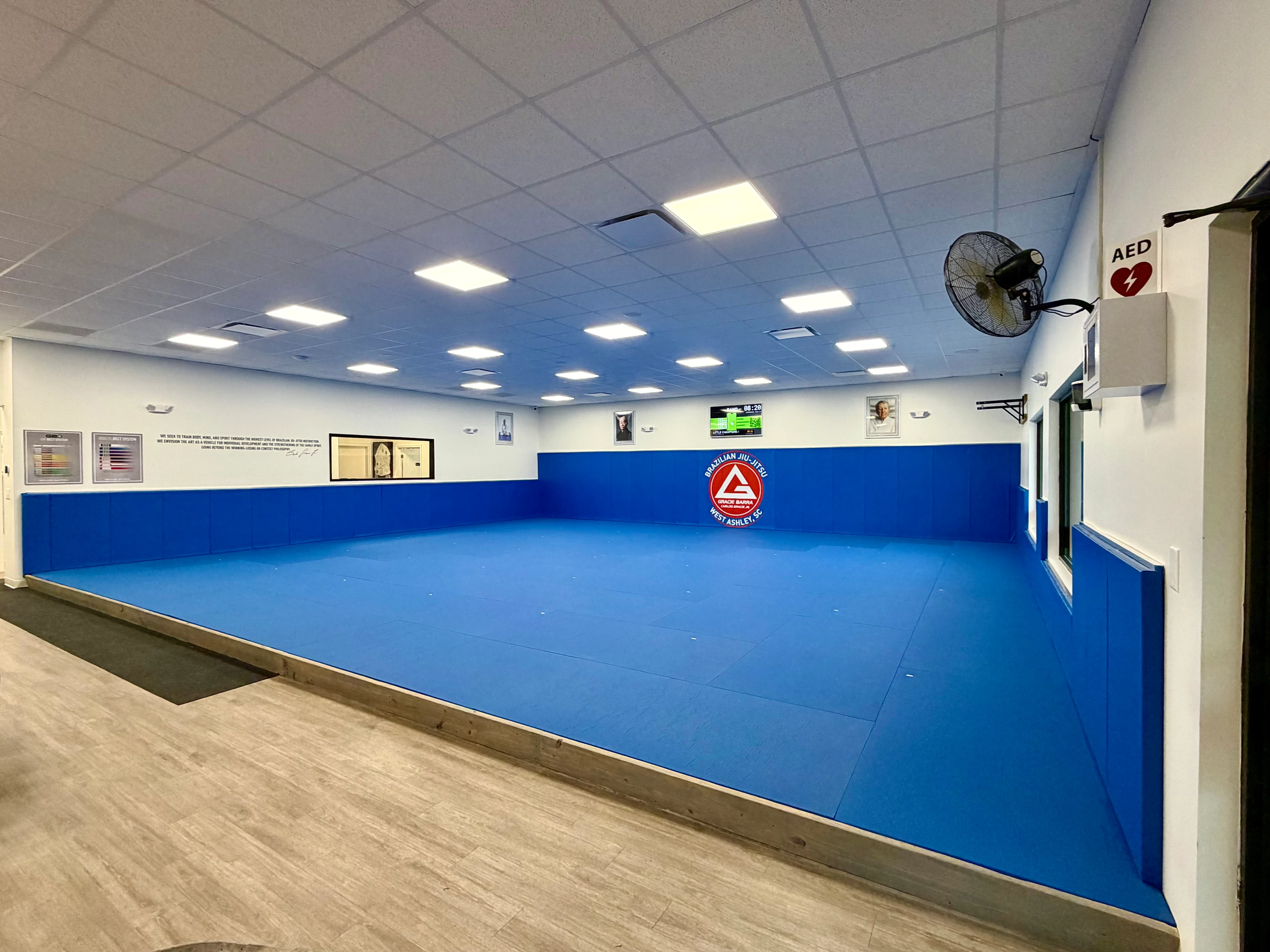 The full blue mat area with padded walls at Gracie Barra West Ashley